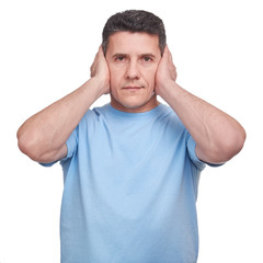 Naklejka premium Portrait adult man closing his ears with two hands. He is afraid to hear about bad things or problems.