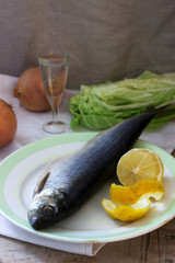 Still life of herring, lemon, onion and vodka. Rustic style.