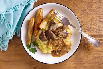 Beef liver with pears and mashed potato. View from above, top studio shot