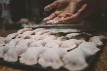 flour hands baking dumpings polish pierogi