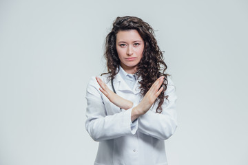 Young doctor - a girl in a white dressing gown. Deliver hands wide, without showing consensus....