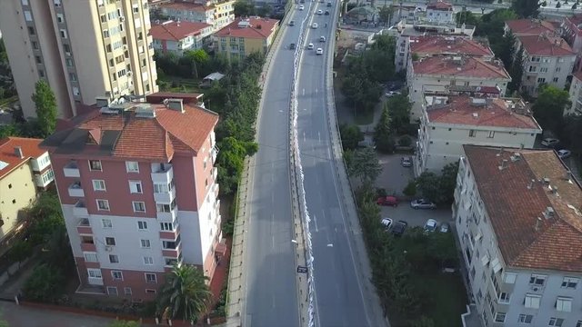 Overlooking the vehicle motion on elevated road junction and interchange overpass. Aerial POV. Drones or unmanned aerial vehicles, extremely popular and versatile because they can operate without huma