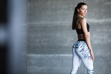 Young woman in sportswear posing in gym.