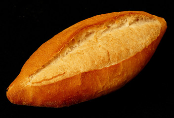 fresh baked whole bread on a black background, close-up,
