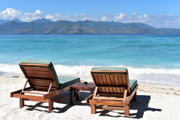 Sun umbrella with chair longue on the tropical beach in Gili Trawangan Island, Lombok, Indonesia