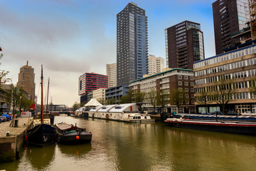 ROTTERDAM, NETHERLANDS - APRIL 13, 2018: Ships on river of the city Rotterdam. Buildings on background.