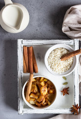 Rice pudding or porridge and fruits (apple, pear, banana and raisins) with honey or maple syrup and spices. Healthy breakfast or dessert.  