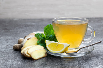 Ginger and lemon drink on gray table