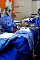 Team surgeon at work in operating room. Surgical light in the operating room. Preparation for the...