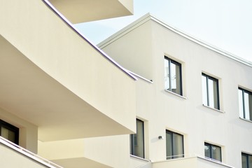 Modern white building with balcony on a blue sky