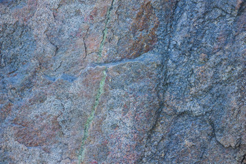 Granite texture close up. Granite rocks with porous surface. Background from solid stone. Pattern with natural material