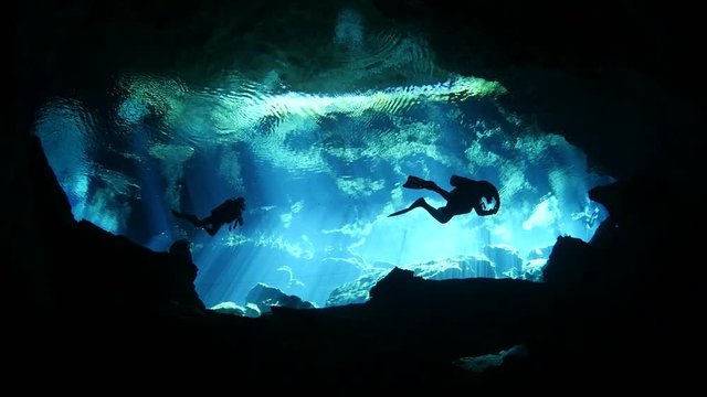 scuba diver exploring a cave