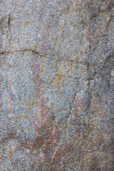 Granite texture close up. Granite rocks with porous surface. Background from solid stone. Pattern with natural material