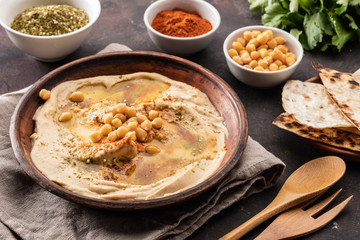 Classic Hummus with chickpeas, paprika, olive oil and oriental spices. Mediterranean popular snack of chickpeas and tahini pasta.