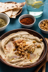 Classic Hummus with chickpeas, paprika, olive oil and oriental spices. Mediterranean popular snack of chickpeas and tahini pasta.