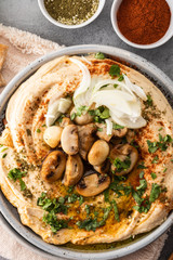Traditional Mediterranean hummus with mushrooms and onions. Classic Hummus with paprika, olive oil, onions, mushrooms and seasonings