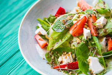 tasty summer salad on a wooden table