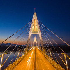 Obraz premium Budapest, Hungary - Aerial view of the illuminated Megyeri Bridge at blue hour