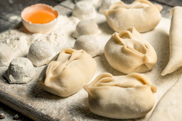 Fototapeta na wymiar Traditional oriental, Uzbek cuisine, chuchvara, manti and samsa, a set of dishes made in one set