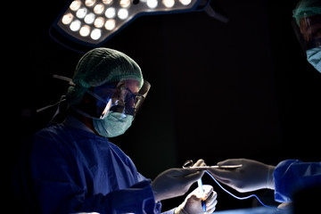 Team surgeon at work in operating room. Surgical light in the operating room. Preparation for the...