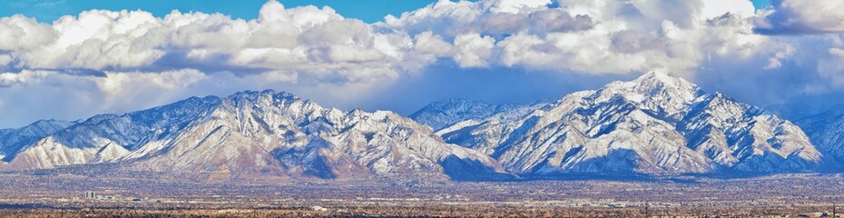 Winter Panoramic view of Snow capped Wasatch Front Rocky Mountains, Great Salt Lake Valley and Cloudscape from the Bacchus Highway. Utah, USA. - obrazy, fototapety, plakaty