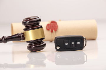 pplication form for car loan, pen and key on wight table, close up view