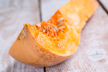 A fresh piece of pumpkin on a wooden background