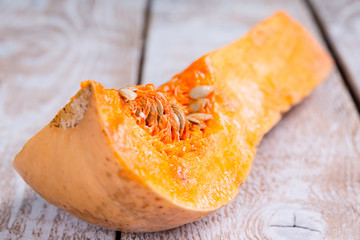 A fresh piece of pumpkin on a wooden background