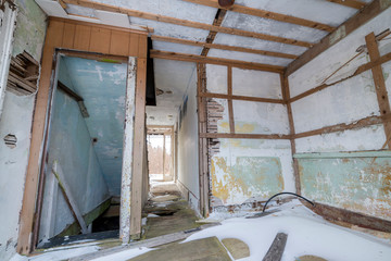 Inside an abandoned house. Walls falling apart. Ceiling damaged.