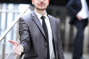 confident businessman holding out hand for a handshake