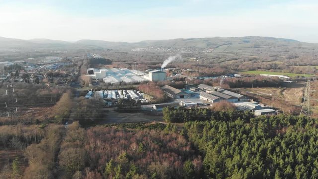 Forward moving drone shot of industrial factory in countryside