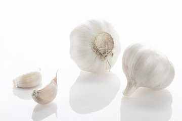 Fresh garlic closeup on a white background. High key.