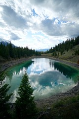 Fototapeta na wymiar Lake Reflection of Clouds in Banff Canada