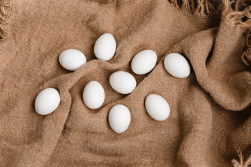 White Chicken Eggs On Burlap Background, Top View