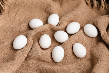 White Chicken Eggs On Burlap Background