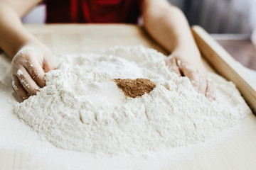 Help children during baking and cooking. The child helps to prepare the dough for baking. Baking cookies, family baking together. Flooding, making cookies. The concept of cooking.