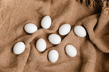 White Chicken Eggs On Burlap Background, Top View