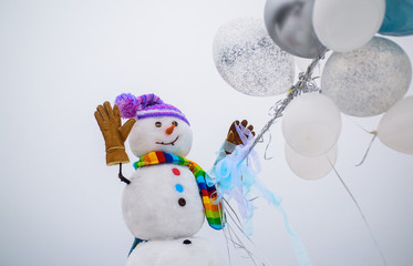 Cheerful snowman dressed for cold weather. Christmas and winter fashion. Snowman in knitted...