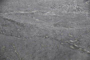 Closeup black soapstone with natural pattern texture background.