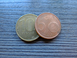 The five euro cent laying over 10 Russian rubles coin, the euro cents have an advantage