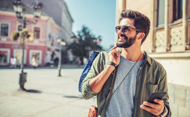 Modern young man enjoying in shopping. Consumerism, lifestyle concept