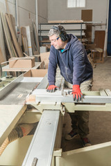 Male carpenter working in his carpentry workshop.