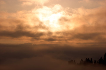 Cloudy sky at early morning in mountains. Magic sky and clouds at dawn. Beautiful morning scene.