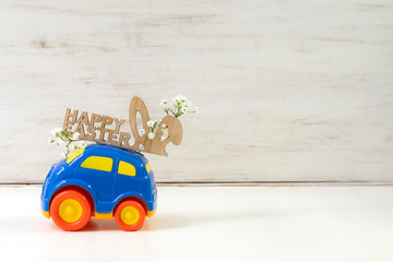 Easter cars with the words  ''Happy Easter'' on a white background, the concept of the approaching...