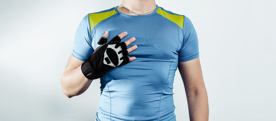 Taking care of your appearance, training at the gym. Sport and health concept. Athlete dressed in a sports shirt prepared for training. Preparing for hard training. Weightlifting, being fit.