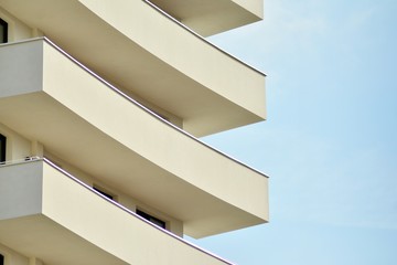 Modern white building with balcony on a blue sky