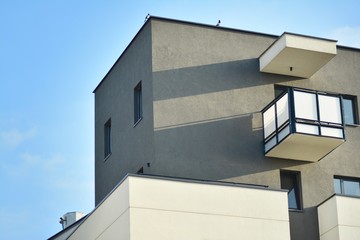 Modern white building with balcony on a blue sky