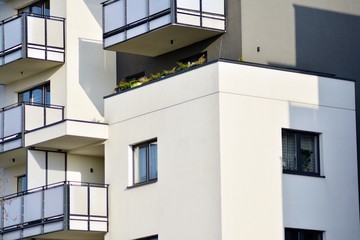 Modern white building with balcony on a blue sky