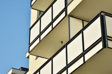 Modern white building with balcony on a blue sky