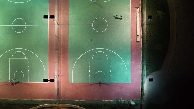 Aerial view of people playing at basketball court during the night, U.A.E.